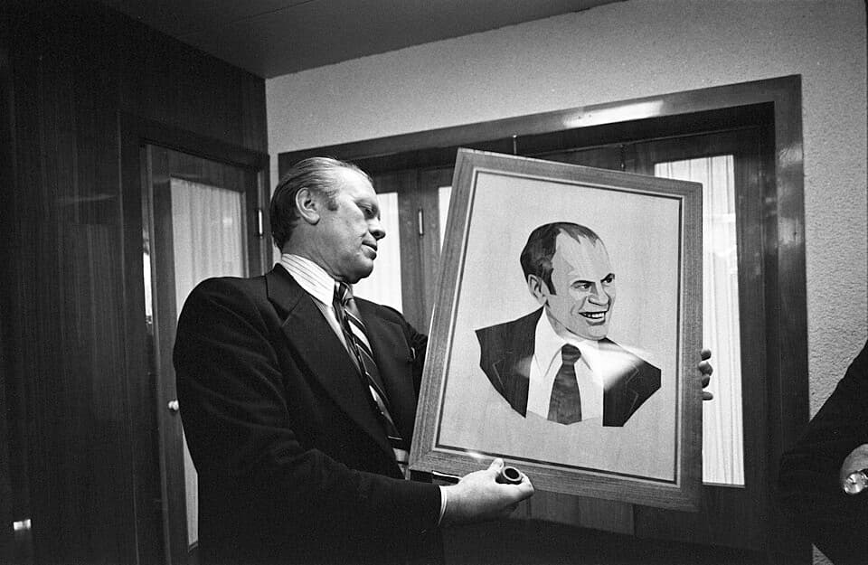 President Ford examines a wood portrait